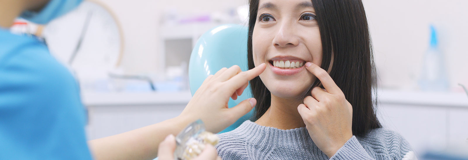 Woman talking to a dentist about dental implants